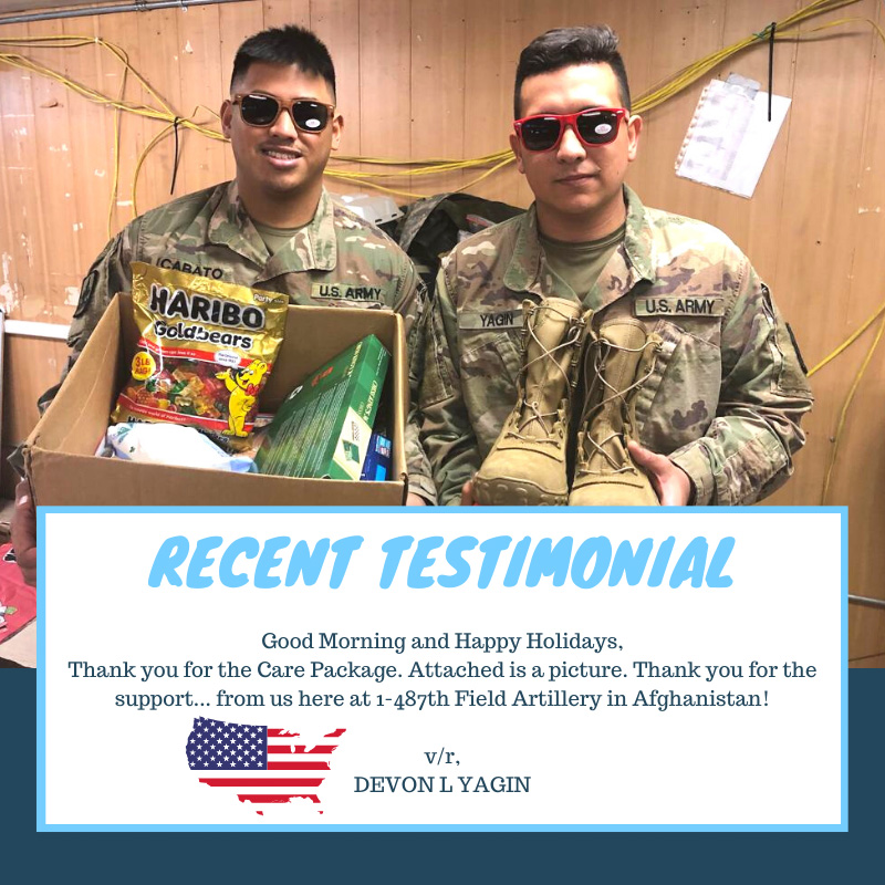 Two young soldiers holding up care package and boots