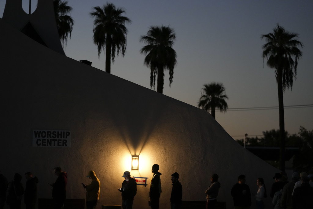 Voters stand in line outside a polling place at Madison Church in Phoenix