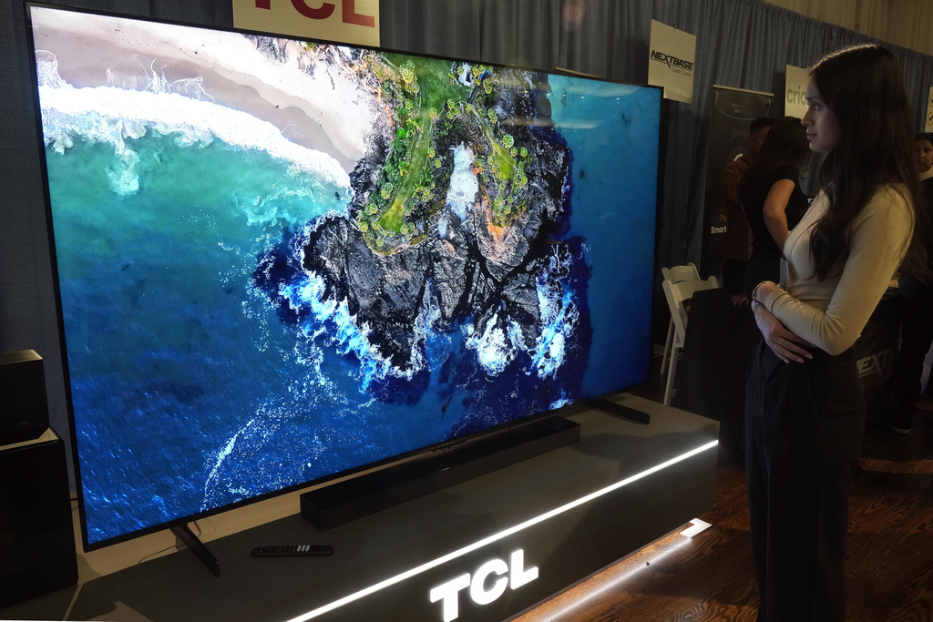 A 98-inch TCL QM-8 Q-Class Mini-LED QLED 4K HDR Smart TV is displayed at the Pepcom Holiday Spectacular event, in New York