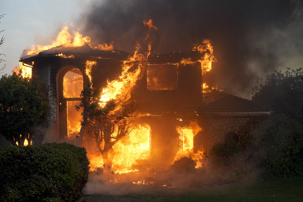 Fire burns a house in the Mountain fire in Camarillo, Calif. 