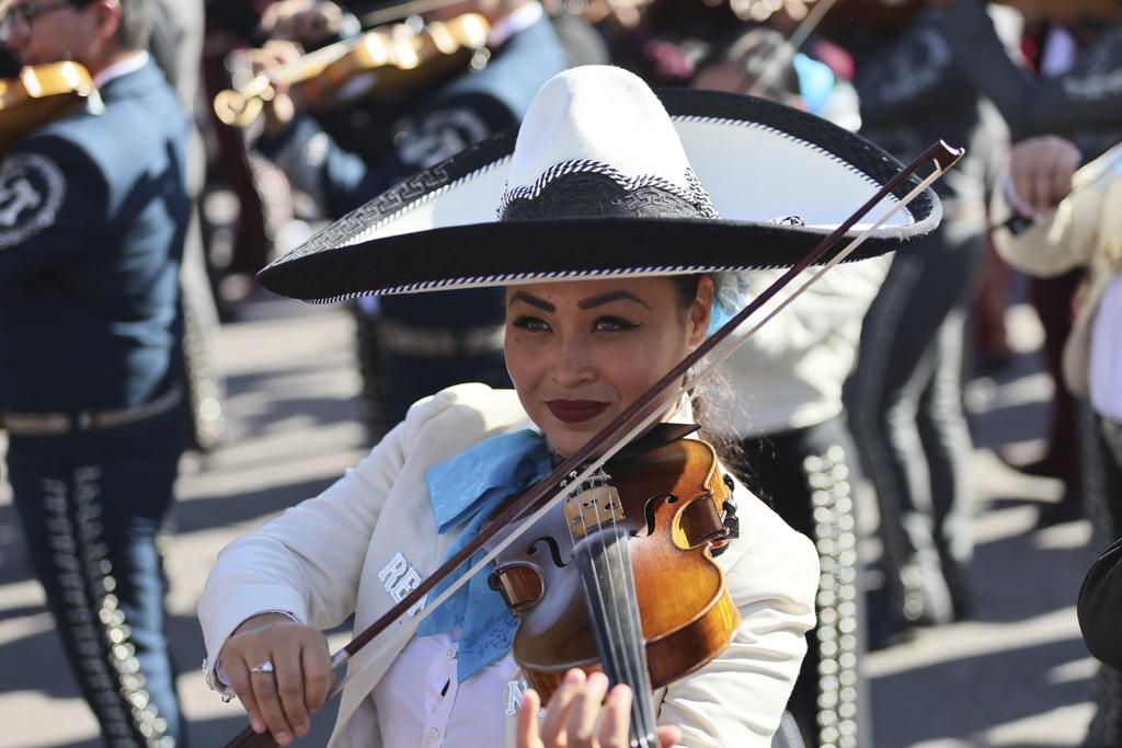 The mariachis played guitars, trumpets, violins and other instruments.