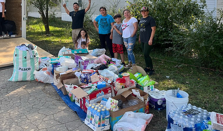 Family with donations in front of them