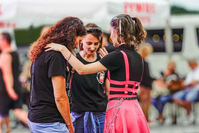 Three young women, praying