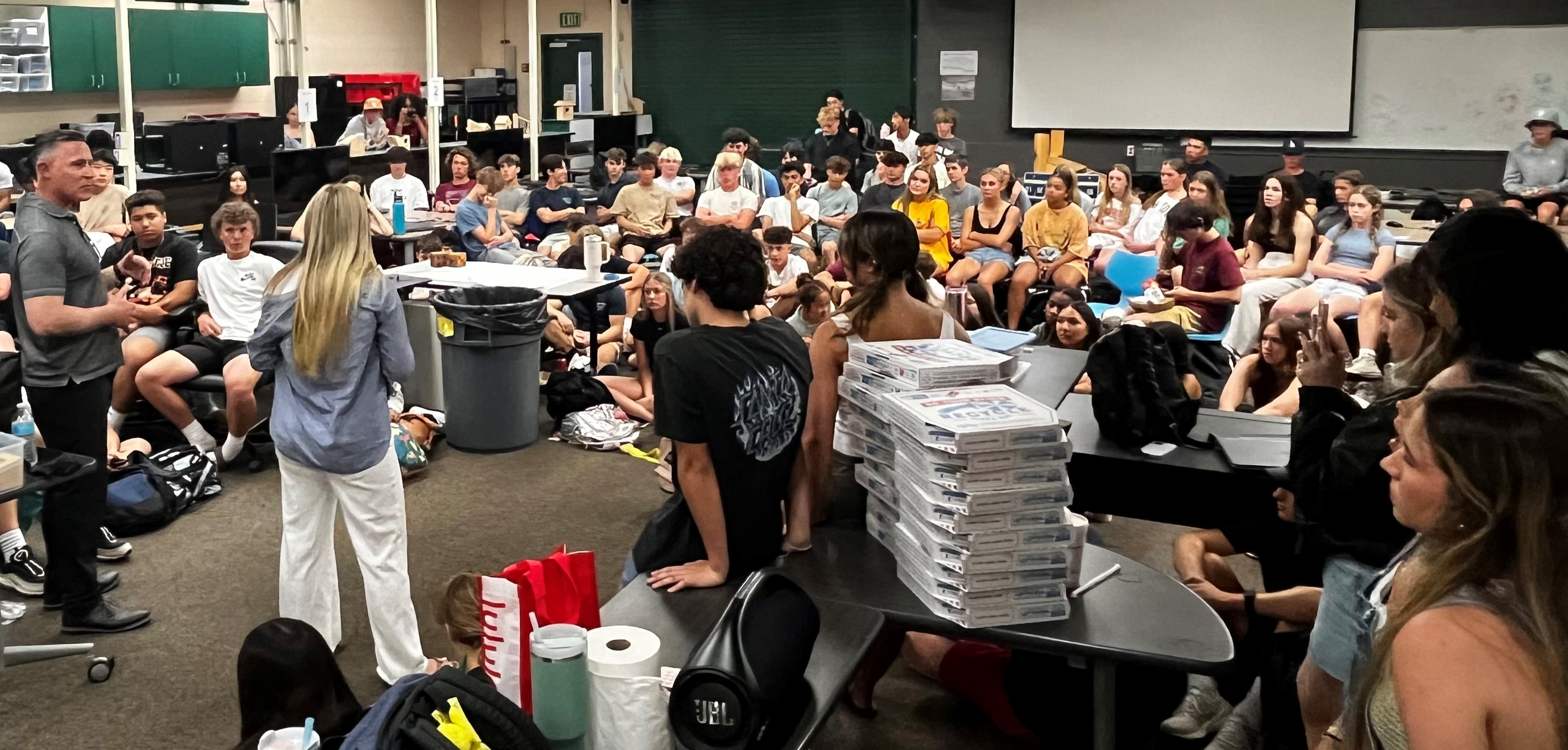 A room filled with students and a few adult leaders