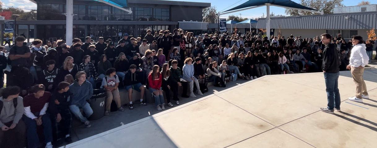 A huge crowd of students circled around a pastor and leader of on campus ministry.