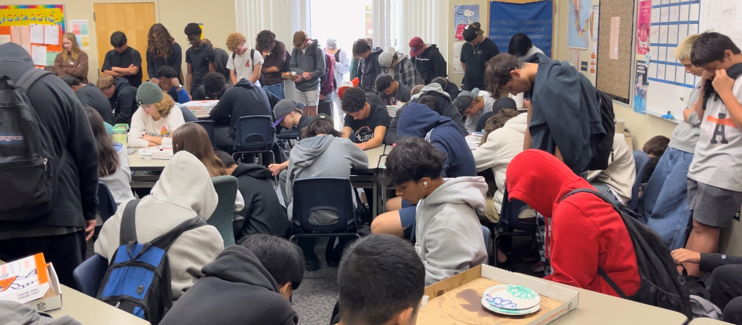 A roomfull of students are praying