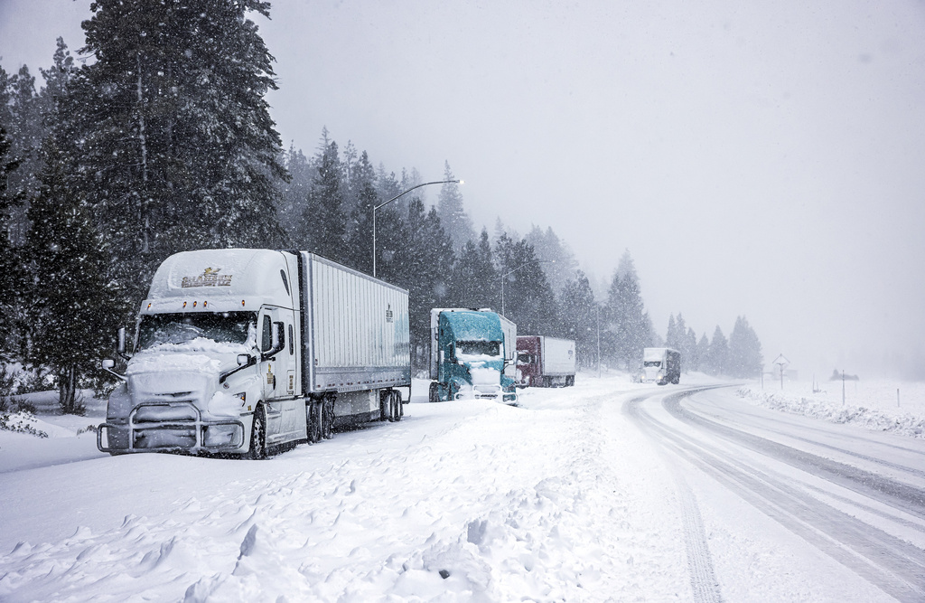 Truckers hole up along the side of I-5 to let the storm pass before the highway is reopened in Weed, Calif., Wednesday, Nov. 20, 2024.