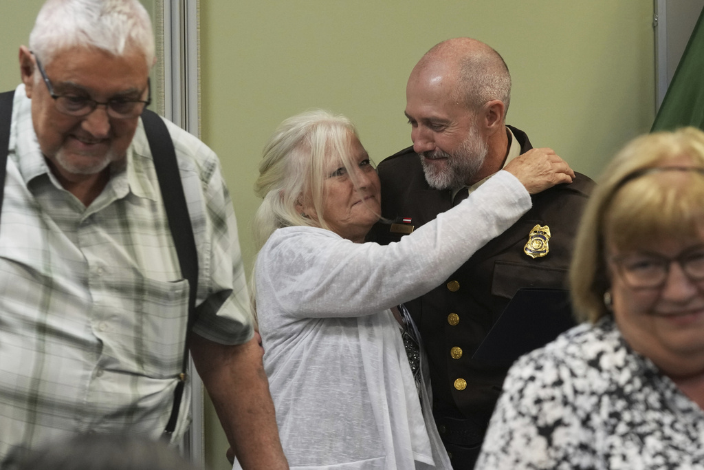 U.S. Fish and Wildlife law enforcement agent is surrounded by his family following the Border Patrol Chaplain Academy graduation