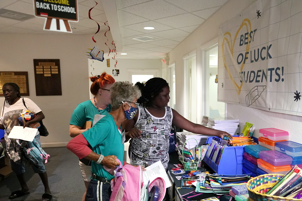 Aaliyah Floyd selects school supplies with volunteer Cindy Blomquist, left, at the annual Back to School Distribution Day at The Pantry in Fort Lauderdale, Fla.