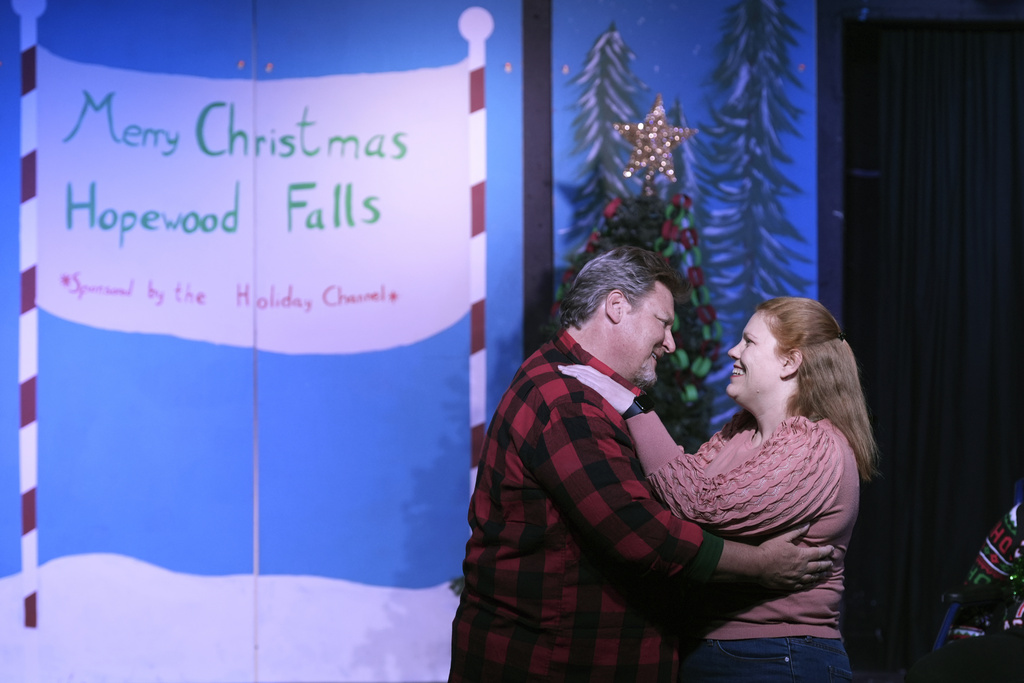 Rebecca Ulbrich, right, and Howie Johnson embrace during a dress rehearsal for the production of "The Holiday Channel Christmas Movie Wonderthon"