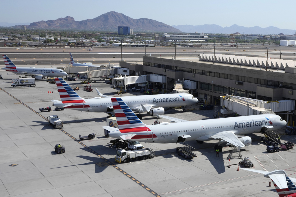 American Airlines planes wait at gates at Phoenix Sky Harbor International Airport 