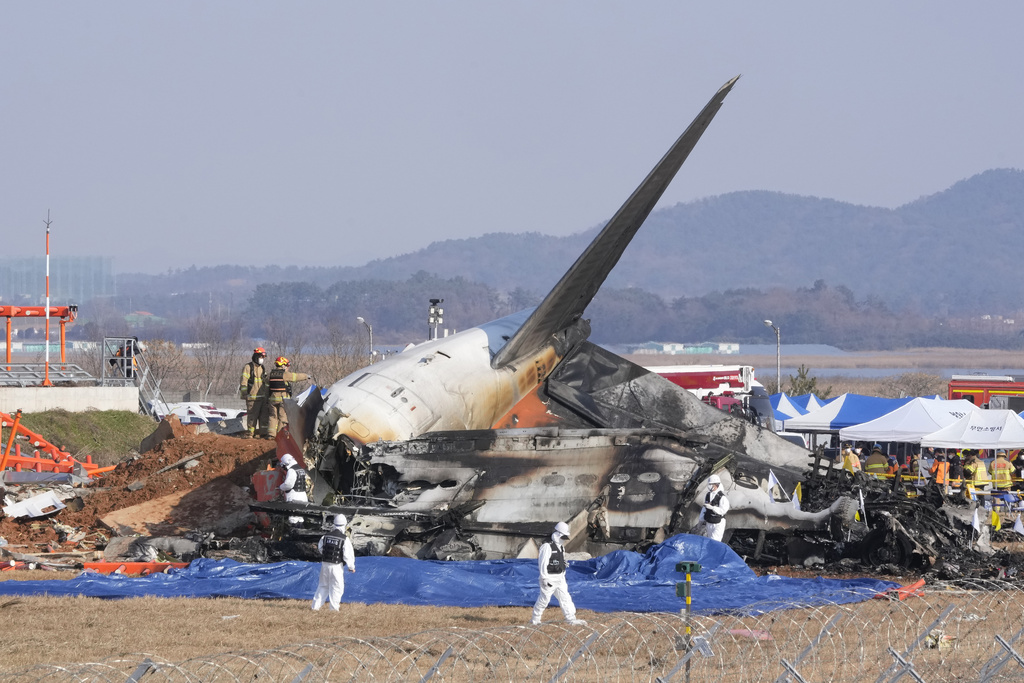 Firefighters and rescue team members work at Muan International Airport in Muan, South Korea