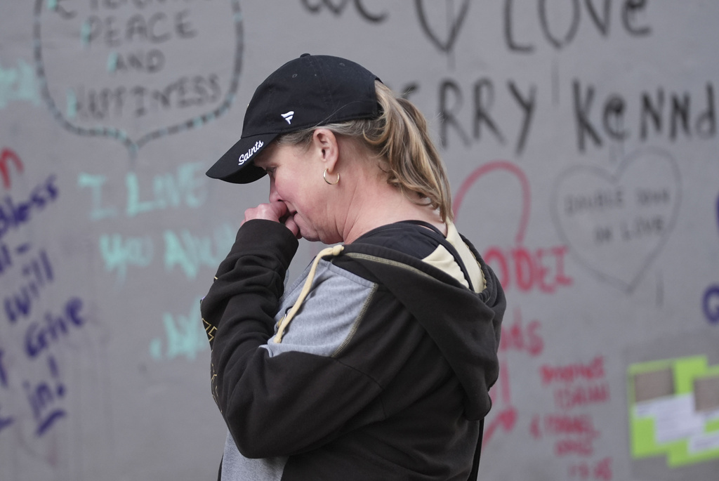 Alisa Kuhns, visiting from Santa Rosa, Calif. reacts at memorial on Bourbon Street for the victims of a deadly truck attack