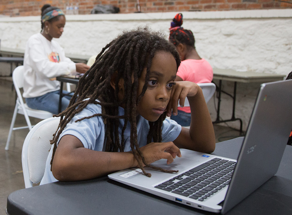 Young person in front of a laptop