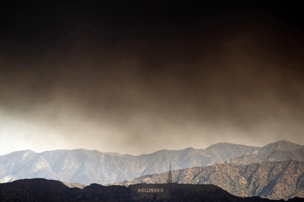 Thick heavy smoke from wildfires passes over the Hollywood sign in Los Angeles