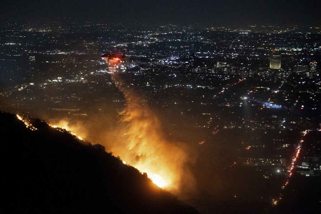 Water is dropped by helicopter on the burning Sunset Fire in the Hollywood Hills 