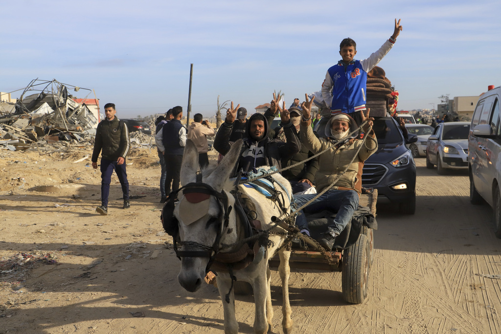 Displaced Palestinians, some armed, return to Rafah, as a ceasefire deal between Israel and Hamas went into effect, in Rafah, Gaza Strip