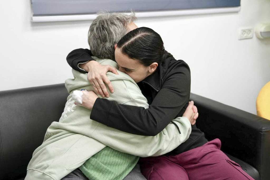 Emily Damari, right, and her mother Mandy embrace near kibbutz Reim, southern Israel after Emily was released from captivity by Hamas militants in Gaza