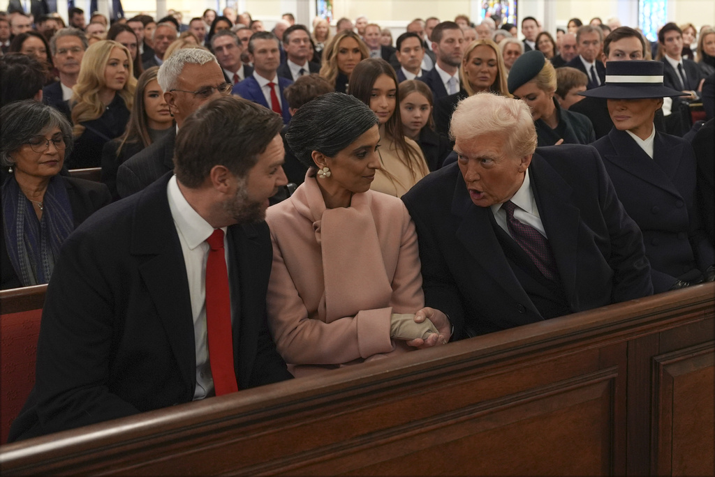 President-elect Donald Trump talks with Vice President-elect JD Vance and Usha Vance before a service at St. John