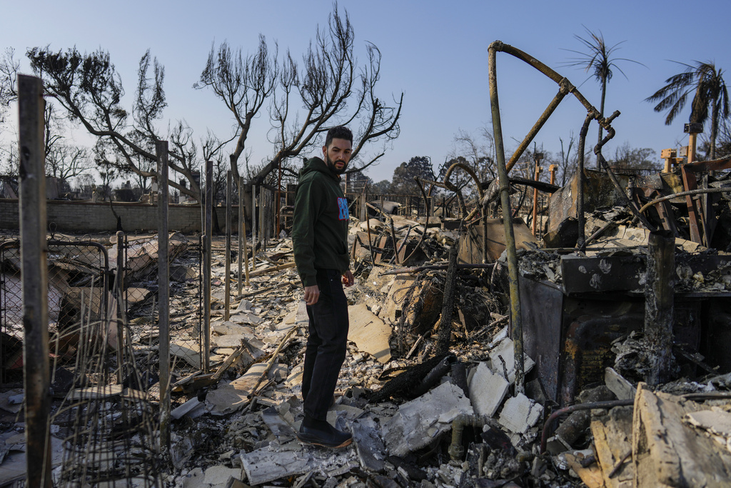 World Central Kitchen Chef Corp member Daniel Shemtob pauses as he walks through what remains of his home destroyed by the Palisades Fire