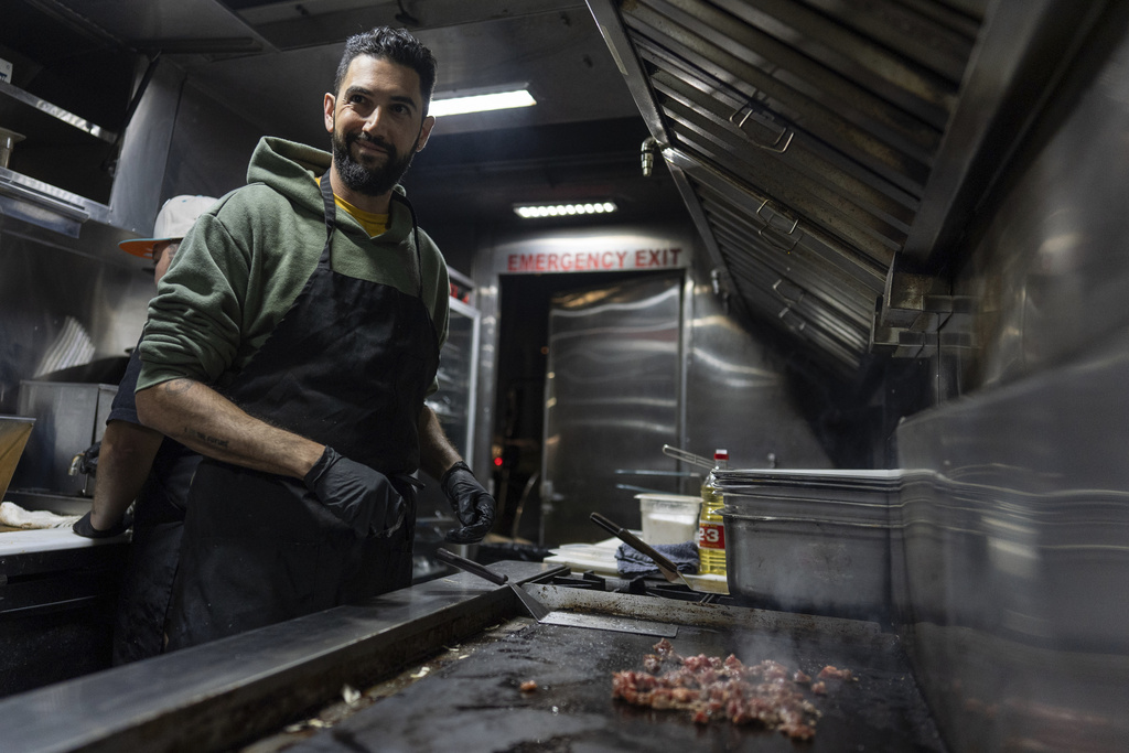 World Central Kitchen Chef Corp member Daniel Shemtob cooks meat for burritos in his food truck, The Lime Truck, for Eaton Fire first responders