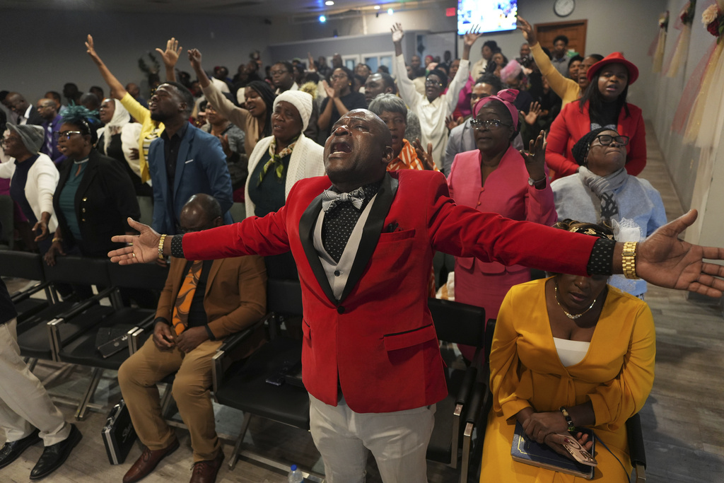 Jean-Michel Gisnel cries out while praying with other congregants at the First Haitian Evangelical Church of Springfield