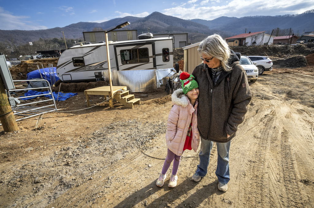 Vickie Revis and her granddaughter, Addisun Cole, 8, stand outside the trailer on Revis