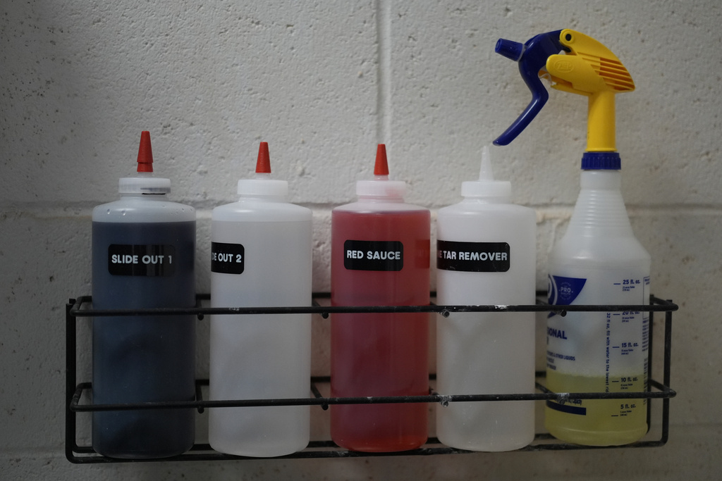 Solutions to clean a variety of stains and pine tar are stored above the San Francisco Giants laundry room sink 