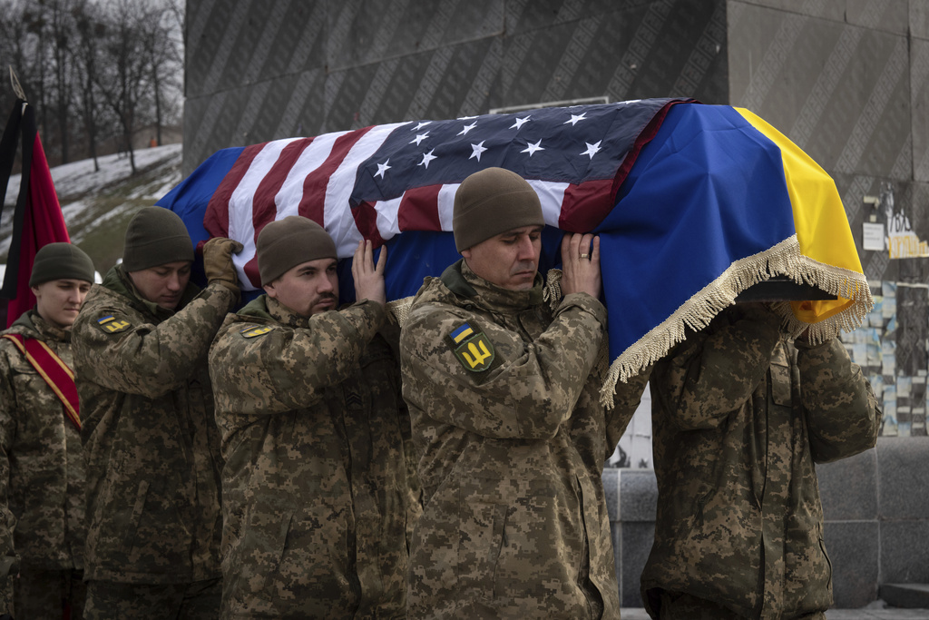 Ukrainian soldiers carry the coffin of U.S. Marine Corps veteran Ethan Hertweck, 21, who lost his life in defending Ukraine against the Russian troops