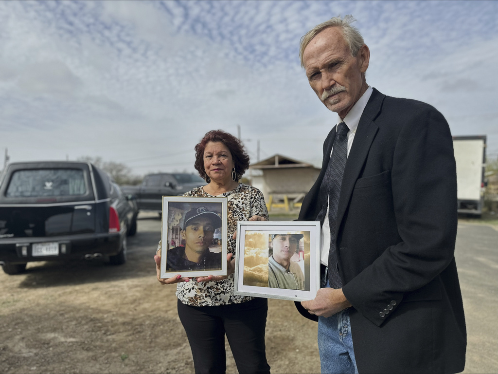 Immigration advocates hold photos of Gustavo Alfonso Garcia Olivares, during his funeral who drowned crossing the Rio Grande into the U.S.