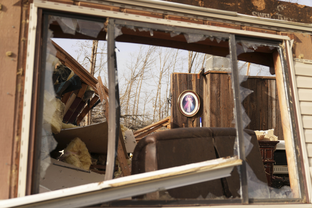 A image of Jesus hangs displayed inside a home belonging to Tim Scott, who was standing near the image when his house was destroyed by a severe storm the evening before in Wayne County, Mo.