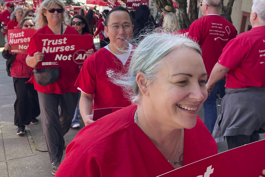 Melissa Beebe, foreground, and other nurses hold a rally in San Francisco to highlight safety concerns about using artificial intelligence in health care.