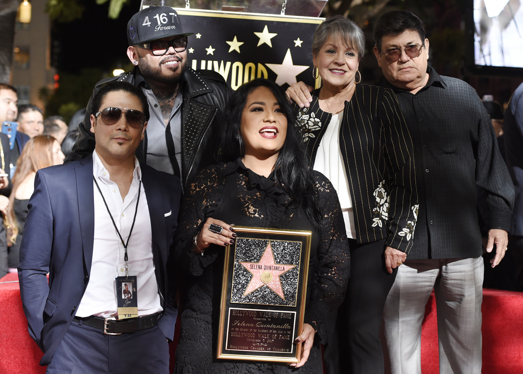 Suzette Quintanilla, center, sister of the late singer Selena Quintanilla, holds a replica of Selena