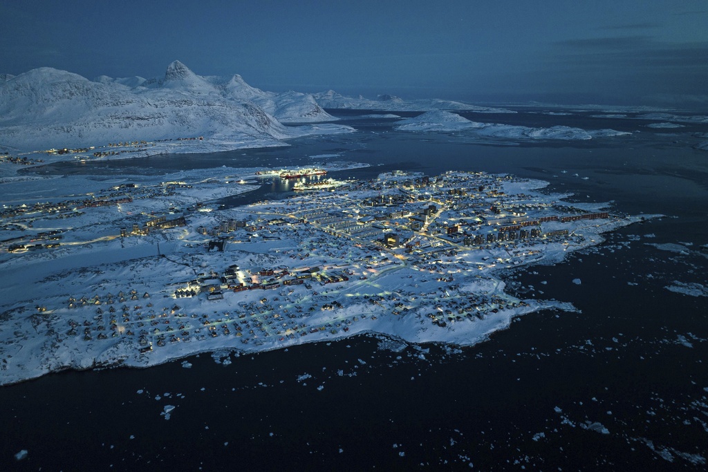 Houses covered by snow are seen on the coast of a sea inlet of Nuuk, Greenland