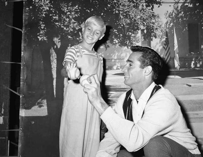 Los Angeles Dodgers pitcher Sandy Koufax, right, gives TV star Jay North some pointers on pitching