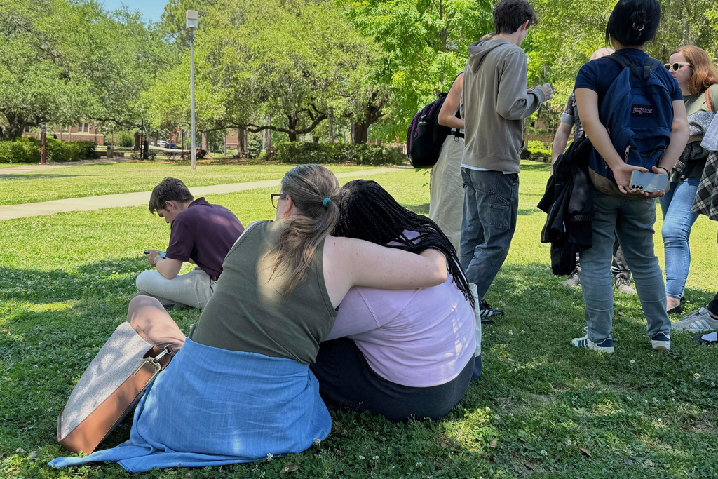 People comfort each other on Florida State University’s campus in Tallahassee, where law enforcement responded to a reported active shooter incident 