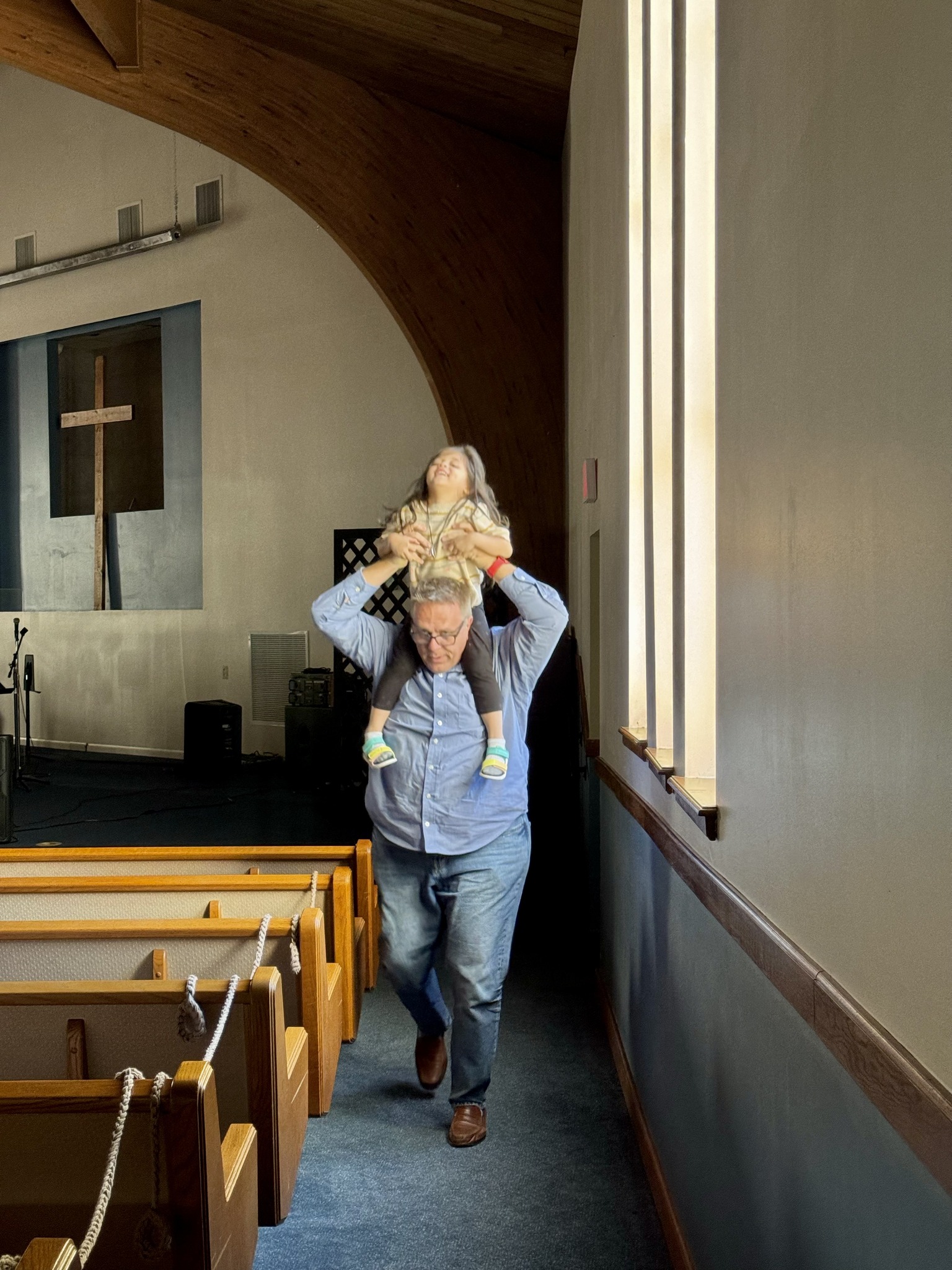Jubilee Being Carried Through The Church On The Shoulders Of Pastor Joel