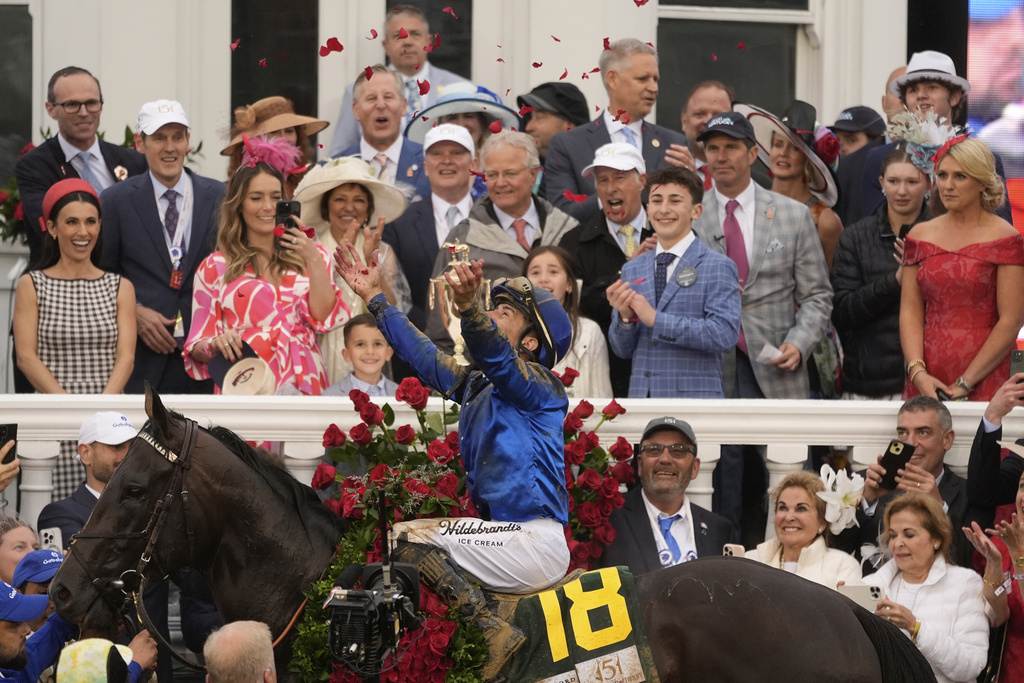 Jockey Junior Alvarado celebrates after riding Sovereignty to victory in the 151st running of the Kentucky Derby