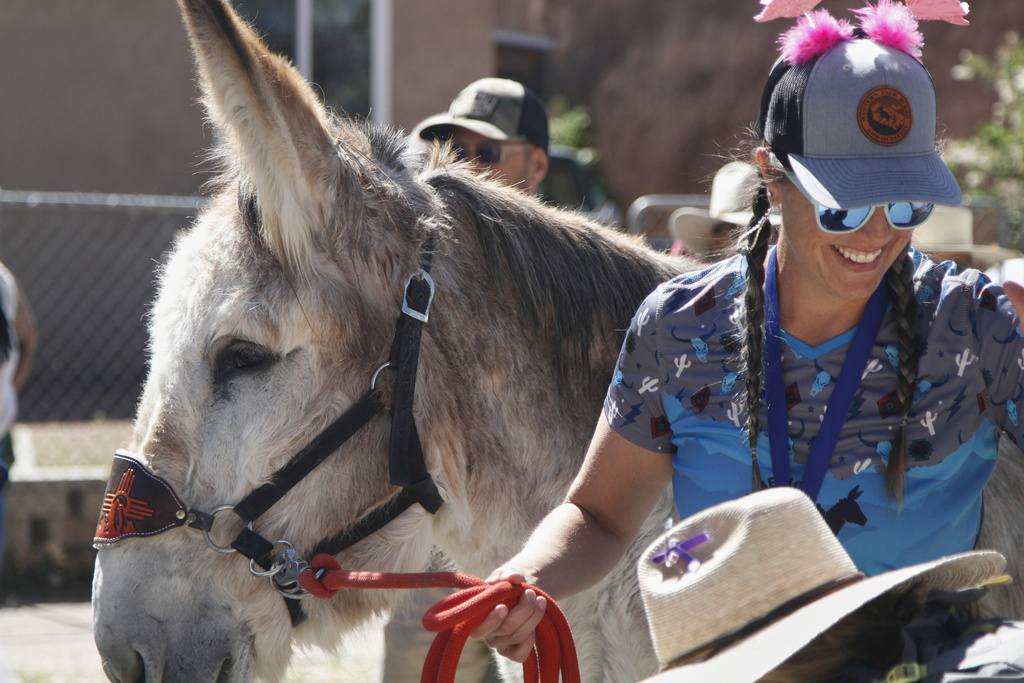 Pack burros and their human companions race through the streets of a former mining town and across backcountry desert trails in Cerrillos, N.M.