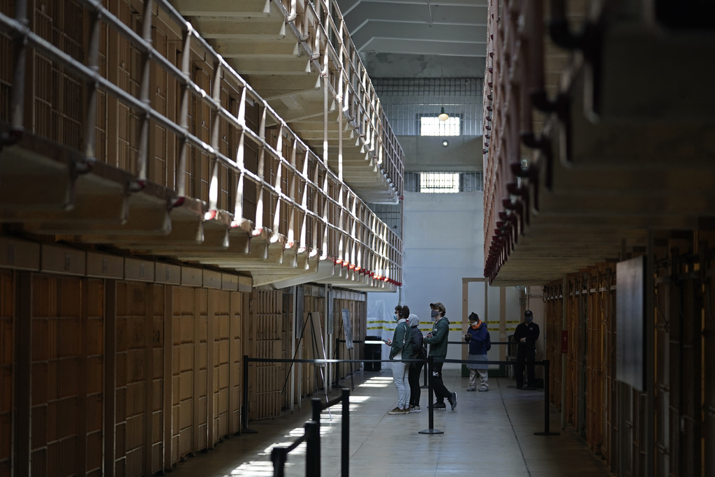 People tour the main cell house on Alcatraz Island in San Francisco