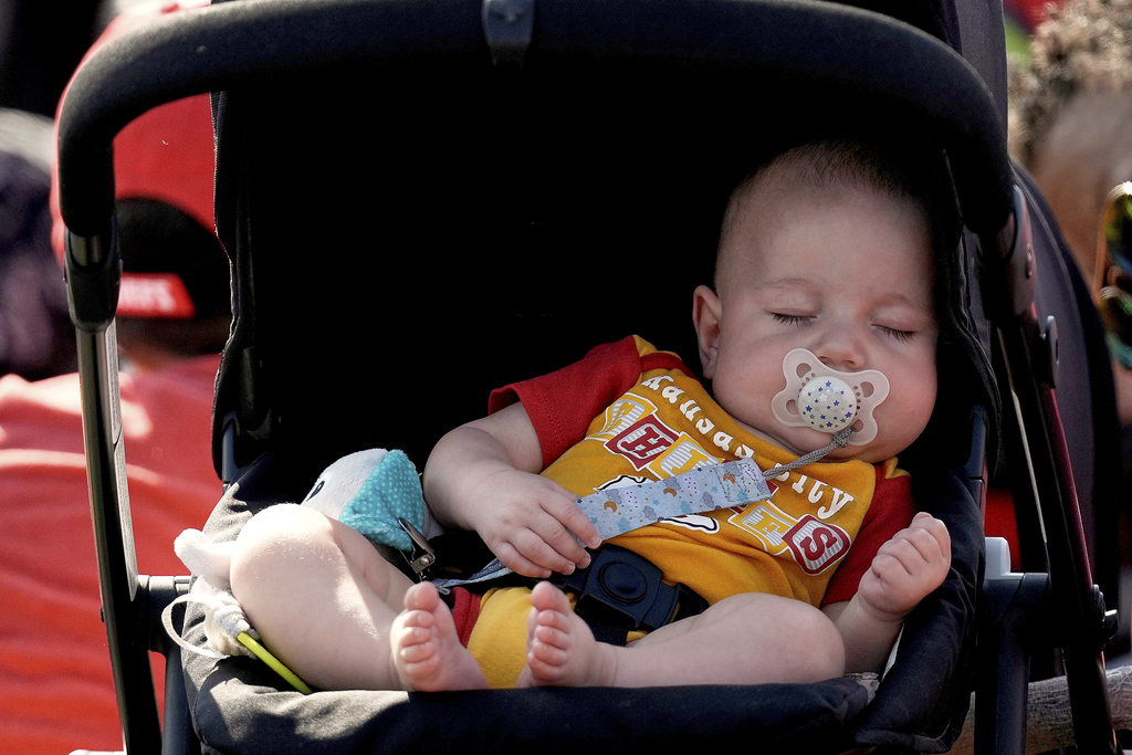 A baby sleeps during NFL football training camp for the Kansas City Chiefs