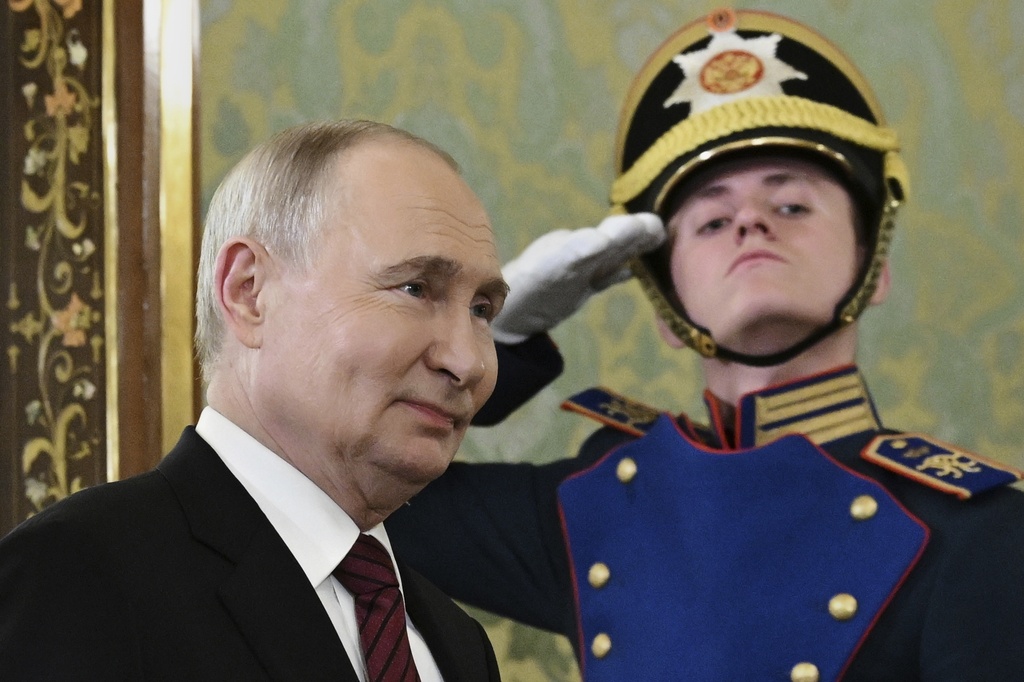 Russian President Vladimir Putin enters a hall to meet South Ossetian President Alan Gagloyev in the Grand Palace at the Kremlin in Moscow