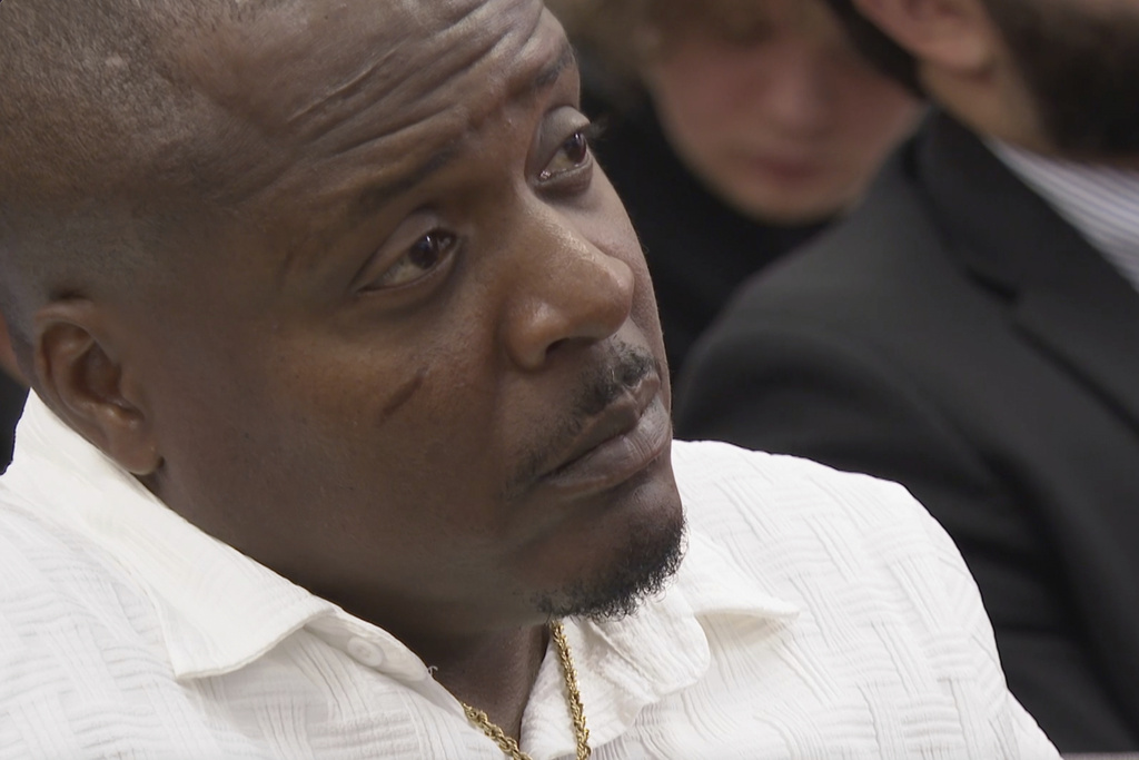 Jermaine Hudson listens as Bobby Gumpright speaks to lawmakers