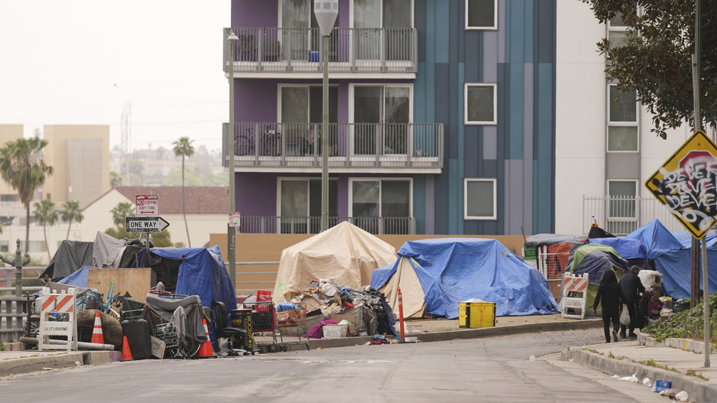 Tents are set up along a freeway in a homeless encampment in Los Angeles