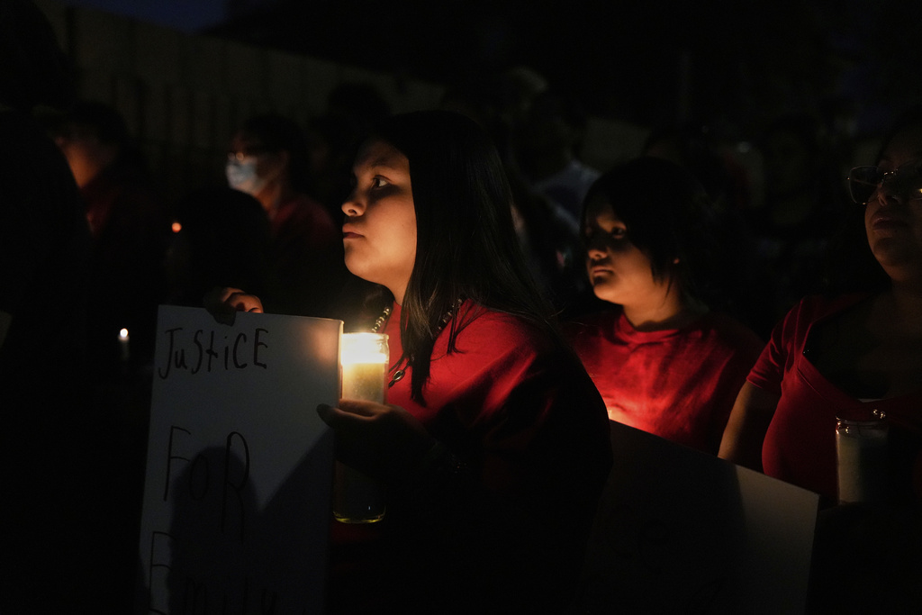People attend a vigil for slain Native American teen Emily Pike in Mesa, Ariz.