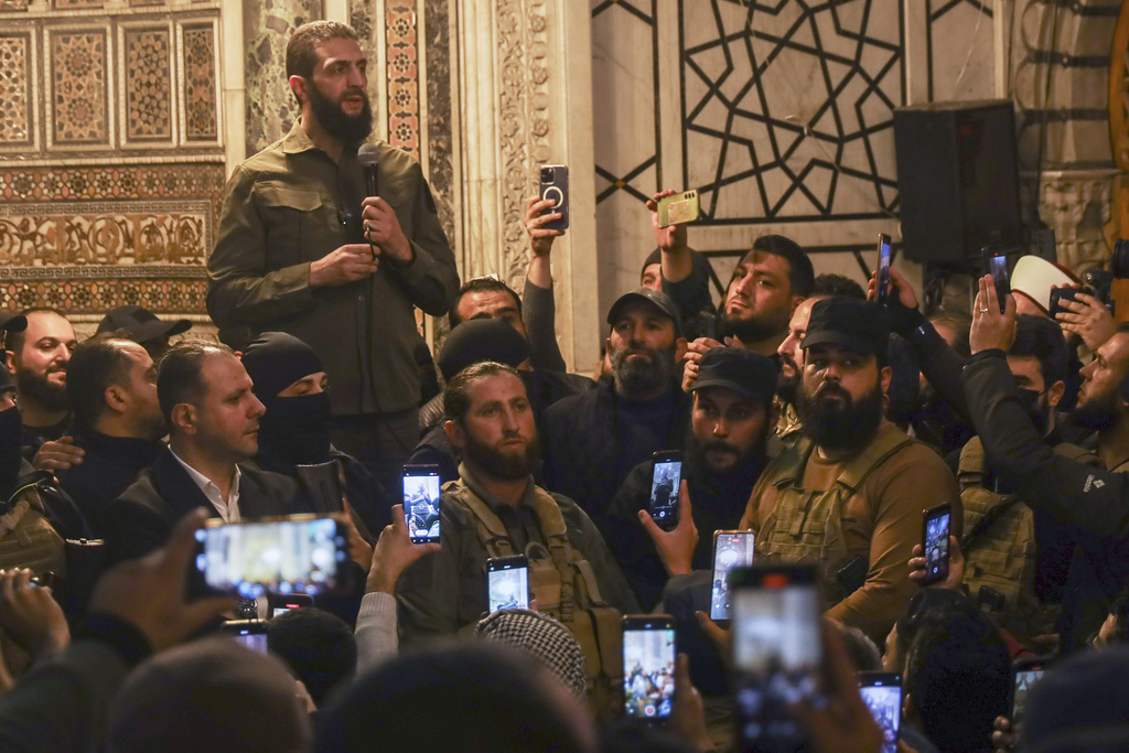 Abu Mohammed al-Golani speaks at the Umayyad Mosque in Damascus